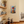 Vintage stye sign hanging on a cream coloured kitchen wall with an image of a stack of colourful coffee cups 