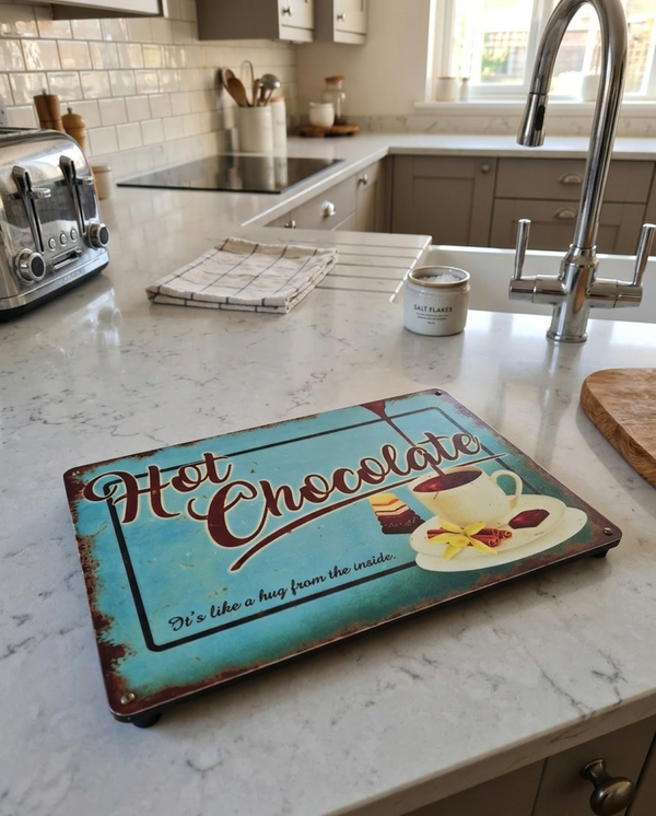 VINTAGE STYLE METAL SIGN (REPRODUCTION) HOT CHOCOLATE, BEING USED AS A SERVING PLACEMAT ON A KITCHEN WORKTOP