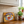 Vintage style Marmite sign on a kitchen counter leaning against the tiled wall below the kitchen units