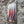 VINTAGE STYLE METAL SIGN WALL ART - OTHER SIDE ANGLE- HANGING ON A BRICK WALL WITH THE IMAGE OF THREE CHILLIS ON IT