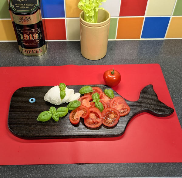 YAKISUGI WHALE STYLE ASH SERVING BOARD displayed with Caprese salad in a kitchen setting