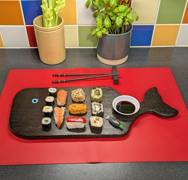YAKISUGI WHALE STYLE ASH SERVING BOARD displayed with Sushi in a kitchen setting