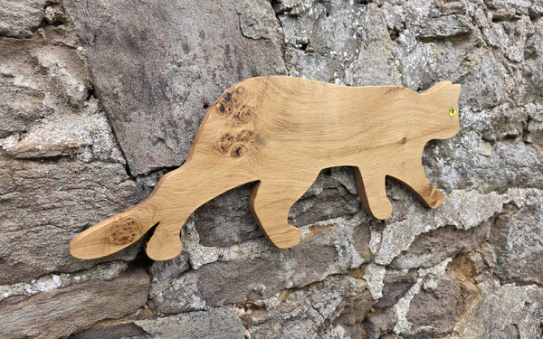Stalking cat wooden wall art viewed at an angle