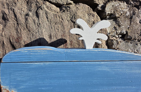 Blue whale rustic wooden wall art displayed on a stone wall with a close up of the white coloured blowhole