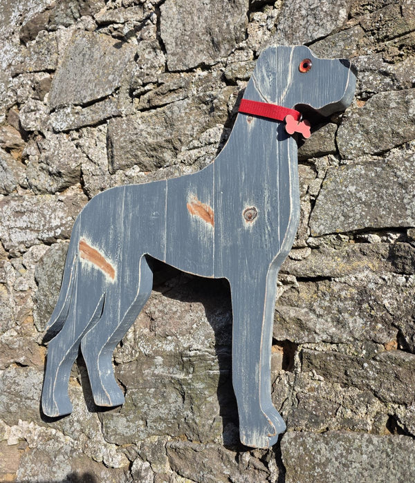 Wooden Great Dane dog wall art with a red collar against a stone wall