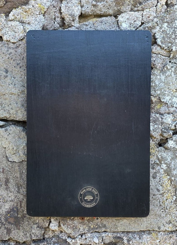 Black coloured back of sign with Oak and Still company logo on it