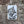 A rectangular vintage style metal sign with a distressed white background featuring a black-and-white owl image and the text 'ARE YOU POOPING!' in black. The sign is photographed against a stone wall.