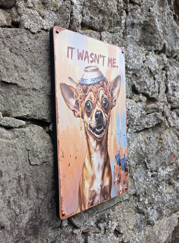 A VINTAGE STYLE METAL SIGN (REPRODUCTION) OF A  CHIHUAHUA DOG WITH AN UPTURNED BOWL OF SPAGHETTI ON ITS HEAD - DISPLAYED ON A STONE WALL AT AN ANGLE