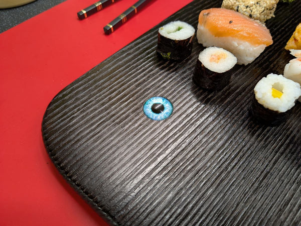 YAKISUGI WHALE STYLE ASH SERVING BOARD showing a close up view of the glass eye & woodgrain