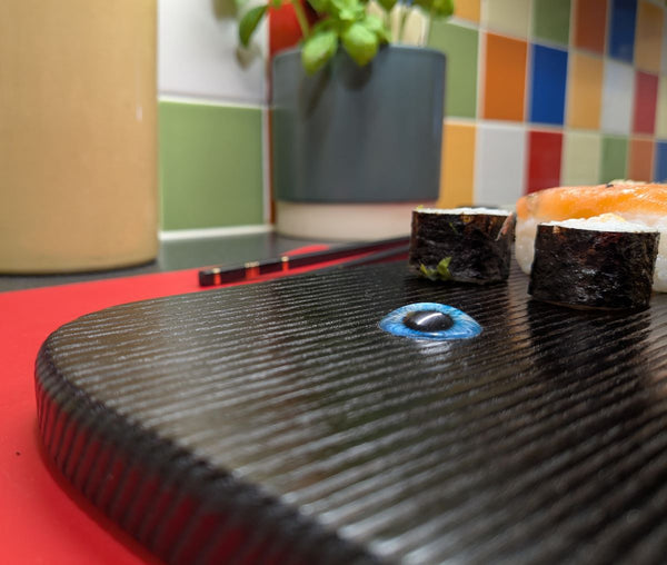 YAKISUGI WHALE STYLE ASH SERVING BOARD showing another angle close up view of the glass eye & woodgrain