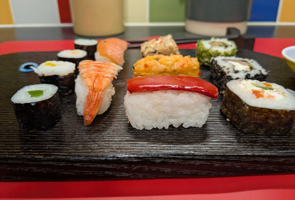 YAKISUGI WHALE STYLE ASH SERVING BOARD displaying a selection of sushi