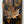 Douglas Fir & flame painted copper maple leaf wall art display piece hanging on a wall very close up view of copper leaf
