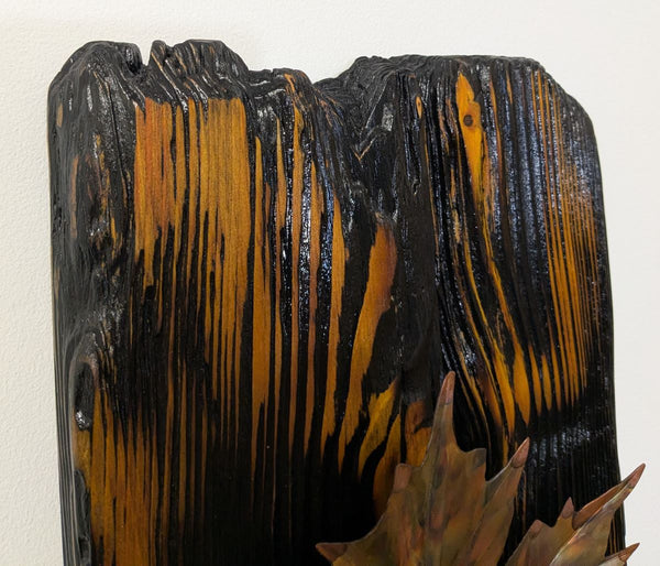 Douglas Fir & flame painted copper maple leaf wall art display piece hanging on a wall very close up view of wood grain finish