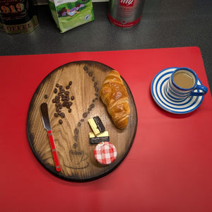 Ash wood 'Coffee Bean style' serving board displayed with croissant, butter, jam & funky red butter knife along side a cup of coffee