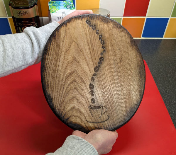 Ash wood 'Coffee Bean style' serving board being held for sizing of the item