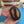 Small ash wood coffee bean being held to show sizing