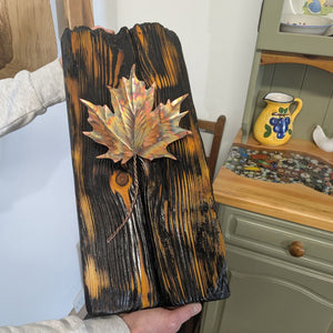 Douglas Fir & flame painted copper maple leaf wall art display piece close up being held for sizing