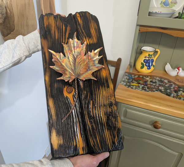 Douglas Fir & flame painted copper maple leaf wall art display piece close up being held for sizing