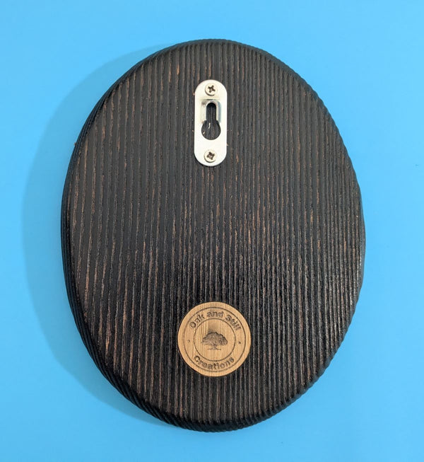 Back of Ash Wooden Coffee Bean showing a wall hanging fixing and Oak and Still Creations Company logo
