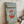 a Vintage style shabby chic, sage green pine wall art shutter with a design on it of a red crock-pot & lid, along with the words 