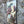 Another side view of a decorative vintage style metal sign (repro) hanging on a stone wall with an image of cheeses and grapes on a cheeseboard