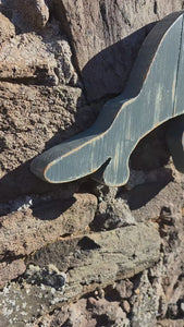 Video of Stalking cat rustic wooden wall art displayed on a stone wall 