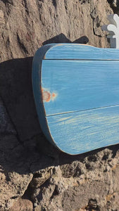 Video clip of Blue whale rustic wooden wall art displayed on a stone wall