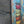Video clip of a repro vintage style metal sign with a colourful image of a stack of  six coffee cups, against a stone wall